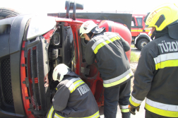 Felborult kisteher motorterét vizsgálják a tűzoltók